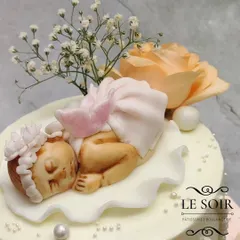 I was so happy to make this baptism cake for baby Renée. This 3 kg two-tier Lemon Blueberry Cream Cheese cake features a delicate sleeping baby figurine, an angel plaque, and is adorned with fresh peach roses and baby's breath.