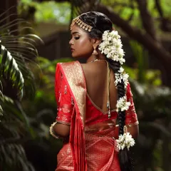 A professional shot from our South Indian bridal series. The focus here is on the beautiful contrast between the red saree, the gold jewelry, and her flawless, glowing skin.