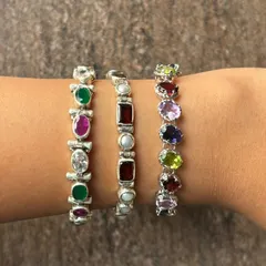 A glimpse of our popular silver stone bracelets stacked on the wrist. We offer a variety of designs featuring semi-precious stones like emerald, ruby, amethyst, and pearl, perfect for adding a pop of colour to any outfit.