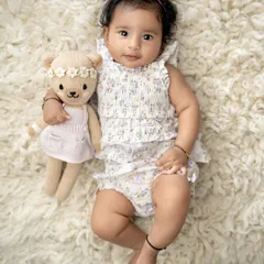 The cuteness of 100 days. This little one, at her 3-month milestone, is looking adorable with her teddy bear friend.