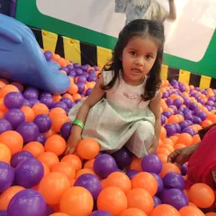 A candid moment in the ball pit. This area is perfect for toddlers and kids to explore textures and colors in a safe, contained space.