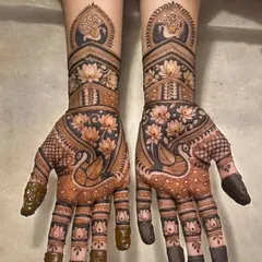 This design is a celebration of nature, with peacocks, swans, and lotus flowers covering the hands in a beautiful, flowing pattern.