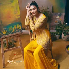Another beautiful shot of the yellow palazzo set, where the model looks like a painting herself. The rich color and intricate embroidery are the highlights of this design.