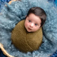 Those wide, curious eyes are just everything. This swaddled newborn portrait focuses on your baby's delicate features, with a simple, cozy setup that keeps them feeling secure.