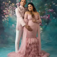 A classic couple's pose against a painterly floral backdrop. My goal is to make you feel comfortable and connected, resulting in maternity portraits that are both elegant and full of love.