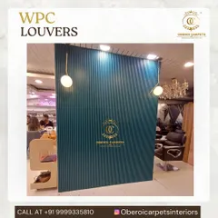 A bold statement wall in a salon using our deep teal WPC louvers. This adds a pop of color and a unique textural element to the commercial interior.
