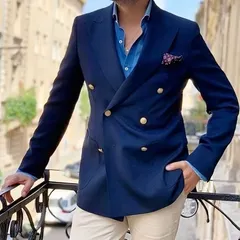 A navy double-breasted blazer is a versatile and powerful piece. Paired here with light trousers, it demonstrates a sophisticated business-casual look, perfect for making an impression.
