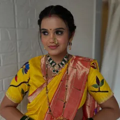 The complete look, showcasing the beautiful yellow and red saree, traditional jewelry, and the elegant braided updo. She looks every bit the perfect Maharashtrian bride.