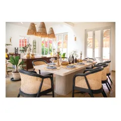 In this Goan dining space, we used natural materials like reclaimed wood, rattan, and earthy Shahbad stone flooring. The interiors are designed to blend in with the context, creating a calm and authentic atmosphere that feels connected to its location.