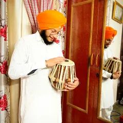 A candid moment of reflection with my instrument. The tabla is more than wood and skin to me; it is a friend and a medium for my expression.