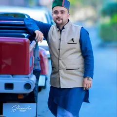 A proud 'Pahari' portrait. The subject's traditional kurta and Himachali cap, combined with a modern vehicle, create a great fusion look.