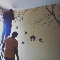 My team working together to paint a detailed wall mural. For artistic projects, we combine careful planning and freehand skill to bring the client's vision to life.