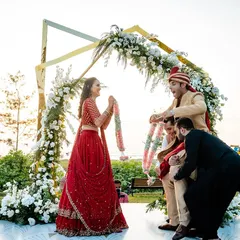 The Varmala exchange is always full of fun and laughter. At this Goa beach wedding, the groom's friends playfully lifted him up, creating a joyful and memorable moment for everyone.