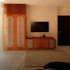 To maximize floor space, I designed a custom media unit that combines a TV console with a sleek, rattan-paneled wardrobe. This integrated approach keeps the room feeling uncluttered and spacious.
