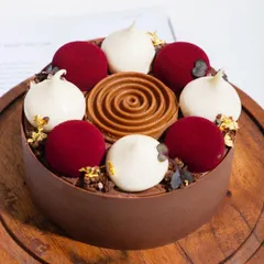 A modern take on the classic Black Forest cake, with delicate spheres of cherry mousse, white chocolate cream, and a rich chocolate base.
