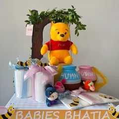 A full view of the Winnie the Pooh hamper, personalized for 'Babies Bhatia' with a honey-drip banner and adorable character toys.