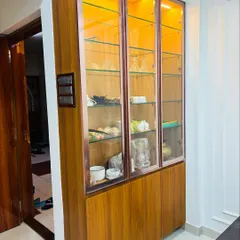 A full view of the wooden and glass crockery unit, showing its ample storage capacity and how its warm tones can complement any dining or living area.