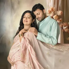 I believe in capturing the shared joy of this journey. This portrait shows a serene moment between partners, styled with a beautiful traditional saree to create a soft, painterly memory of their love and anticipation.
