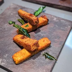 Fried tapioca, or 'Kappa Varruthathu', is a beloved Kerala snack. These tapioca fingers are crispy, savory, and garnished with fried curry leaves. It's simple, delicious, and very addictive.