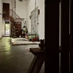 A view into the heart of the heritage home, where shadows and light play across the narrow, deep space. The design preserves the home's soul while making it functional for modern life.