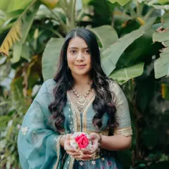 A beautiful portrait of the bride holding flowers. Her makeup is kept minimal and fresh to let her natural beauty shine.