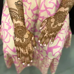 A full view of the elegant Arabic floral design, showing how the pattern flows beautifully from the fingers up to the forearm.