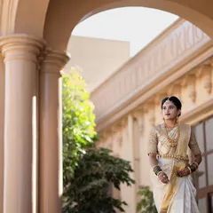 A full portrait of the bride on her wedding day. The makeup is designed to be timeless, pairing perfectly with her traditional white Kanchivaram saree, temple jewellery, and elegant hair bun.