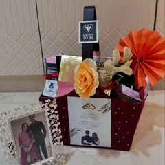 A special hamper for the groom-to-be. This basket is filled with goodies and includes a beautiful antique silver photo frame, all curated to celebrate his upcoming wedding.