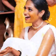 A candid shot of the bride's infectious laughter during her Haldi. These are the unposed, genuine moments that truly tell the story of your wedding day.