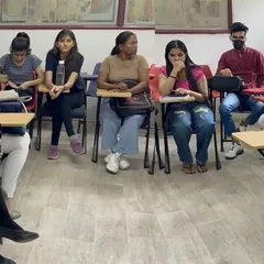 Our classes are designed for interaction. This picture shows a typical group discussion setup where students are seated in a circle, ensuring everyone gets a chance to speak, participate, and receive personal attention from the faculty.