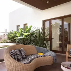 A cozy seating area on the terrace, perfect for relaxing and enjoying the outdoors. The wooden deck and ceiling add warmth to the space.
