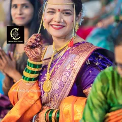 The joy of a happy bride on her wedding day. This photo beautifully captures the final look, including the makeup, the rich stain of her bridal mehendi, and her traditional attire.