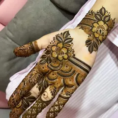 A contemporary floral design with a focus on clean lines and open space. The pattern flows beautifully from the fingers to the wrist.