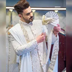 A groom's attire should be nothing short of magnificent. Here, influencer Ayush Khatri is seen during a fitting for his custom sherwani, a masterpiece of intricate embroidery and regal design, complete with a matching turban and stole.