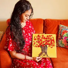 A client holding her custom-made Abundance Tree. The colors and textures are chosen specifically to resonate with her home's energy and her personal intentions for prosperity.