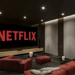 A minimalist home theater setup perfect for a modern home. The design features a large screen, a simple media console, and comfortable, modular seating for a relaxed movie night.