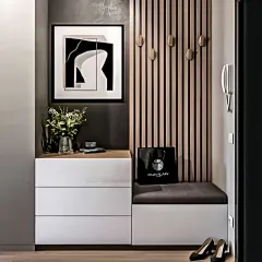 A sleek and modern foyer unit with handleless white drawers and a comfortable seating bench. The vertical wood slats with hooks provide a stylish place to hang coats and bags.