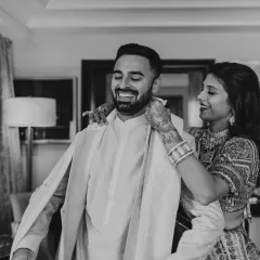 I love finding ways to make wedding outfits last beyond the big day. Here, I'm helping the groom's brother get ready in his repurposed wedding sherwani, which we dyed a new color. It’s a sustainable choice that keeps special memories alive.