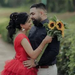 A romantic gaze shared between the couple in a serene garden setting. The sunflowers add a pop of cheerful color, symbolizing adoration and loyalty in this beautiful pre-wedding photograph.