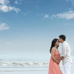 A classic and romantic forehead kiss against the beautiful backdrop of the sea and sky. A timeless memory of this special time.