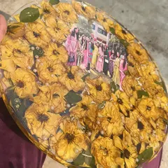A close-up of the friendship frame, filled with bright yellow roses and a cherished group photo from a farewell day.