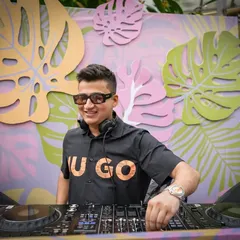All smiles from behind the decks at this fun and colorful poolside event. The decor was as vibrant as the playlist.
