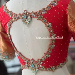 We love adding unique details, like this elegant heart-shaped cutout on a bridal blouse. The intricate zardosi and stone work framing the back adds a touch of modern romance to a traditional design.