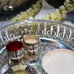 The details of a traditional Godhbarai ceremony are so important. This shot features a beautifully crafted silver tray with kumkum and rice, essential elements for the rituals, set against a backdrop of fresh jasmine flowers.
