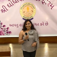 A confident pose with the mic at a ladies' forum event. My one-shoulder top and professional demeanor are perfect for such gatherings.