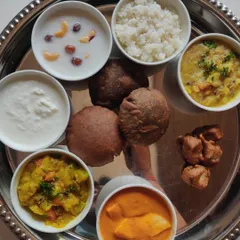 A complete Navratri special thali. This platter includes a variety of fasting-appropriate dishes like Kuttu ki Poori, Samak rice, and paneer curry, all prepared without onion or garlic.