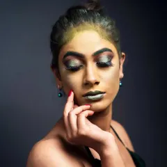 The final 'Green Fairy' fantasy look. Notice the blend of green and gold tones on the skin and the sharp, metallic eye makeup. This is a great example of how to create an ethereal, non-human character.
