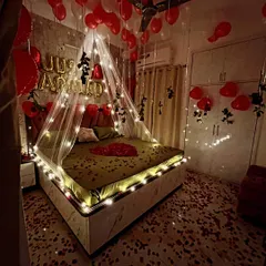 Another perspective of the 'Just Married' room decor, highlighting the placement of balloons on the ceiling and the way the fairy lights illuminate the entire space.