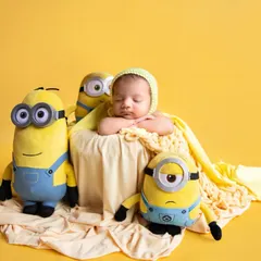 Another angle of the adorable Minions setup. The bright yellow background and plush toys create a cheerful and playful atmosphere for this sleeping baby.
