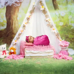 Wrapped in warmth and a little bit of magic. This newborn is sleeping peacefully in a beautiful outdoor-themed setup, complete with a teepee and teddy bears.